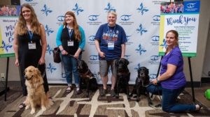 Four AFI 2019 Conference attendees with their guide dogs