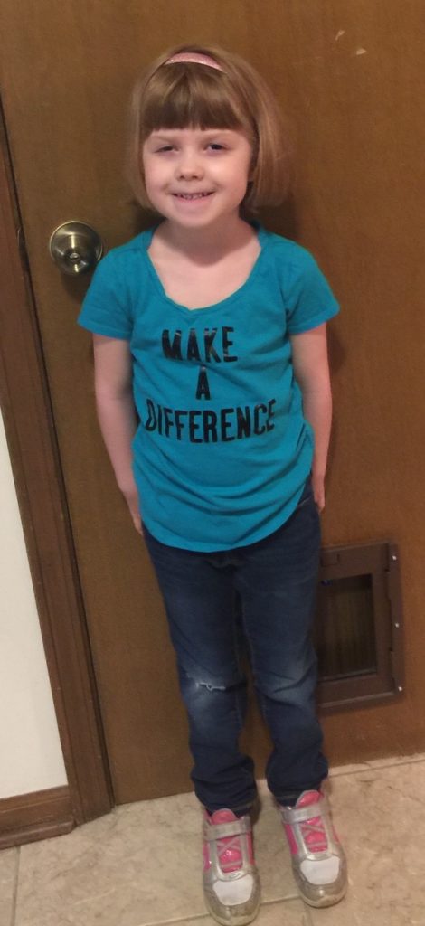 Girl smiling in a "Make a Difference" shirt